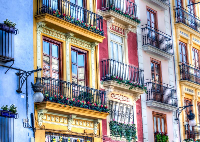 Colourful buildings with balconies - Financial advice for buying a property in Valencia